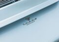 Close-up of a light blue air-cooled 911's rear featuring the "THEON DESIGN" logo and emblem.