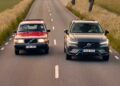 A red classic Volvo and a gray modern Volvo SUV drive side by side on a two-lane road through a rural landscape, highlighting the brand's evolution as Volvo expands U.S. operations with XC60 production from 2026.