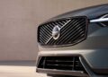 Close-up of the front grille and headlight of a Volvo car, featuring the Volvo logo and diagonal chrome slats, as Volvo expands U.S. operations with XC60 production from 2026.