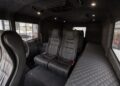 The image shows the interior of an Atlas ATV, featuring four black leather seats and a quilted bench along the passenger side wall. The cabin appears clean and spacious—ideal for anyone seeking an amphibious ATV for sale.