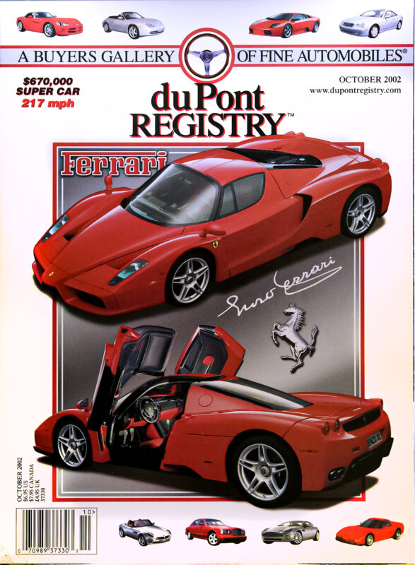 DuPont REGISTRY Cover Cars: October 2002 issue highlighting a red Ferrari Enzo supercar with open door, car details, and Enzo Ferrari's signature—celebrating automotive excellence.