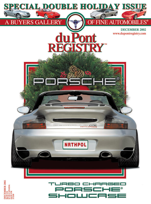 Rear view of a silver Porsche convertible with a "NRTHPOL" license plate and holiday wreath, featured on the 40th Anniversary December 2002 cover of duPont REGISTRY magazine’s iconic Cover Cars.