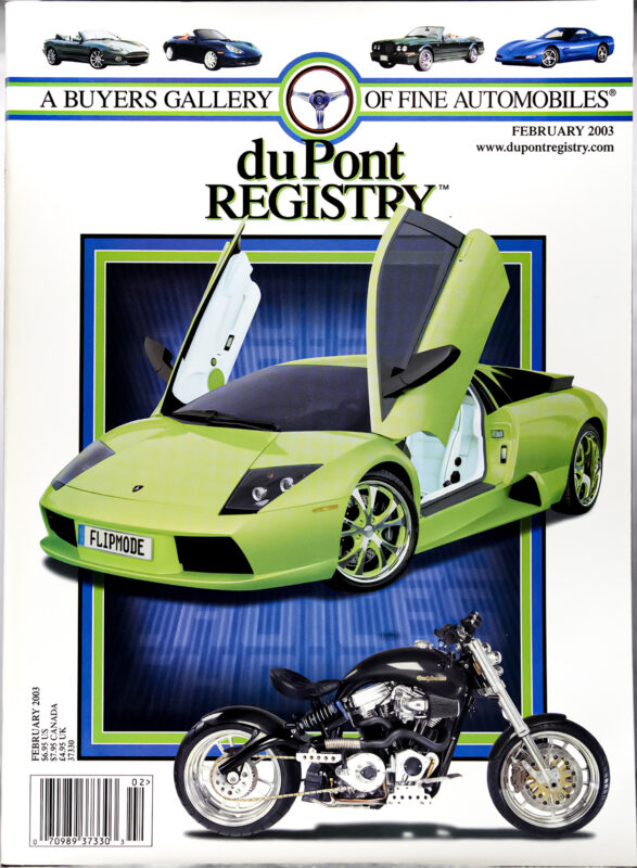 DuPont REGISTRY Cover Cars: February 2003 issue featuring a green sports car with vertical doors and a black motorcycle in front, celebrating automotive excellence.