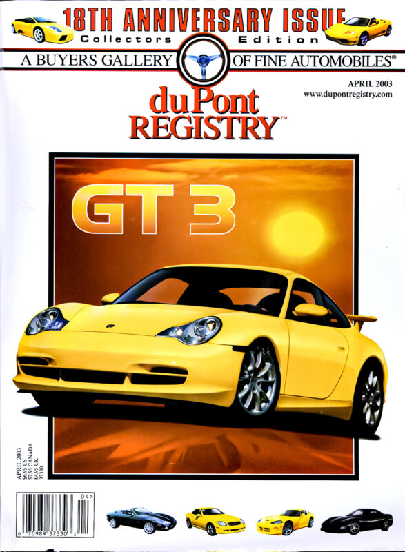 Cover of duPont REGISTRY magazine, April 2003, featuring a yellow Porsche GT3 sports car against a red background with a setting sun, highlighting "18th Anniversary Issue" in the iconic Cover Cars series.