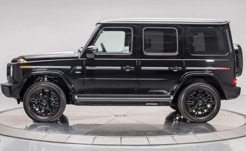 A black Mercedes-Benz G-Class SUV is shown in a studio setting, viewed from the side with black wheels and tinted windows—perfect for those seeking the best car leases on a luxury vehicle.
