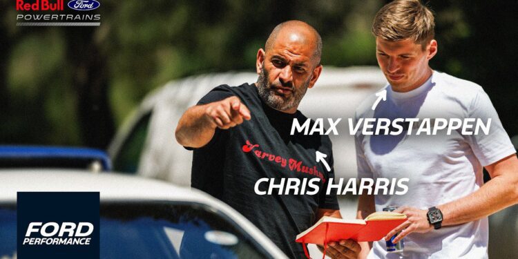 Chris Harris and Max Verstappen stand outdoors beside a Ford Mustang GTD; one points ahead while the other holds a red box. Text labels identify them, with Ford and Red Bull logos visible in the background.