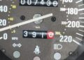 A Ferrari F40 speedometer displays 7,430 kilometers on the odometer and 391.0 on the trip meter. The seatbelt warning light is illuminated—don’t miss your chance to buy now at auction!.