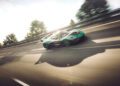 A green Rimac Nevera, one of the fastest EVs, drives at high speed on a highway, with trees and guardrails blurred in the background.