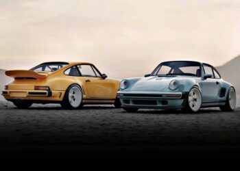 Two classic Porsche 911 cars, reimagined by a California-based singer, sit side by side—one yellow, one light blue—unveiled as the latest Carrera Coupes at Goodwood against a hazy sky backdrop.