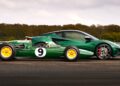 A classic green Lotus race car with yellow wheels is parked next to a modern green Lotus sports car on a racetrack, as Lotus prepares to honor F1 legends Senna and Clark at Goodwood, with trees in the background.