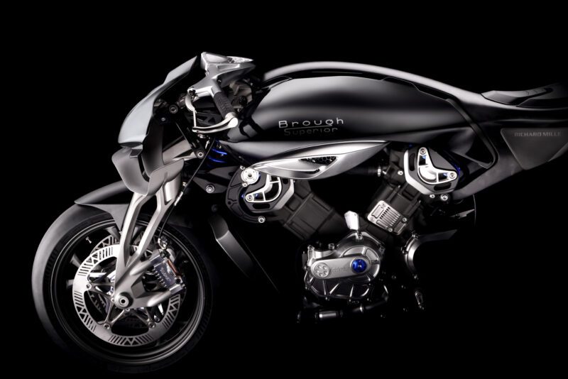 A futuristic black Brough Superior RMB01 Track Motorcycle with exposed engine components, showcased against a sleek black background.