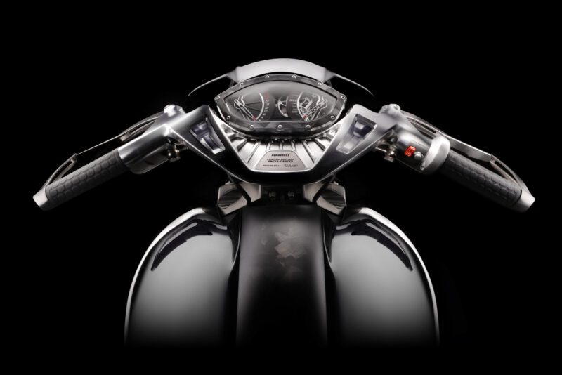 Front view of the RMB01 Track Motorcycle’s handlebars, dashboard, and fuel tank by Brough Superior, set against a black background.