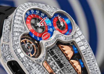 Close-up of a luxury watch with a diamond-encrusted case, two colored dials marked “Bugatti,” and visible intricate mechanical components—an exquisite example of haute horology from Jacob & Co. x Bugatti.