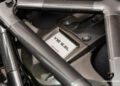 Close-up view of a Lamborghini V12 6.5L engine with visible carbon fiber components and engine label, photographed at Lamborghini Miami—the #50-of-50: LAST Lamborghini Murcielago LP 650-4 Roadster for Sale at Prestige Imports.