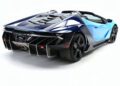 A blue and black Lamborghini Centenario Roadster with angular design, visible rear engine cover, large rear diffuser, and black alloy wheels sits on a white background. Only 10 in the U.S., this luxury sports car truly hits the market with exclusivity.