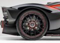 Close-up of the ultra-rare Aston Martin Valkyrie’s rear wheel, featuring a black rim with red accents, large disc brakes, and a Michelin tire—an exclusive hypercar now for sale.