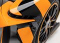 Close-up of an ultra-rare Aston Martin Valkyrie’s wheel and fender, featuring a black and orange geometric pattern and visible aerodynamic detailing, now available for sale.