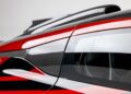Close-up of the ultra-rare Aston Martin Valkyrie's side window, carbon fiber trim, and rear spoiler against a plain background—an exclusive highlight from O’Gara Coach.