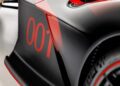 Close-up view of an ultra-rare Aston Martin Valkyrie race car with striking red detailing and the number "001" displayed on the side panel near the rear wheel.