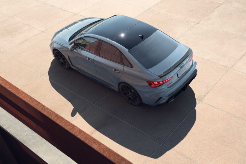 A gray Audi sedan is parked on a tiled surface, viewed from above and slightly behind, with sunlight casting a shadow to the left—a reminder that The Last Surviving 5-Cylinder On Sale Today Packs A Punch.