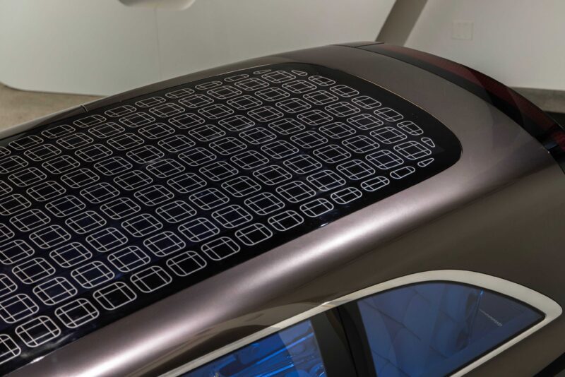 The image shows the roof of a Mercedes-Benz Vision V concept car with integrated solar panels, featuring a grid-like pattern of rectangular cells.