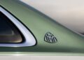 Close-up of a green Emerald Isle Mercedes-Maybach S 680’s rear pillar featuring the Maybach logo badge, with part of the rear window and a silver trim visible on this limited edition model.