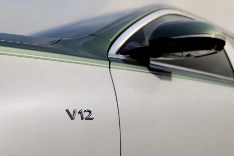 Close-up of the Mercedes-Maybach S 680’s side panel, featuring a “V12” badge and part of a side mirror, hints at this limited edition model’s powerful V12 engine and exclusivity.