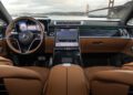Enjoy a glimpse of the luxurious Mercedes-Maybach S 680 interior with brown leather seats, digital dashboard displays, and the iconic Golden Gate Bridge visible beyond the windshield of this limited edition model.