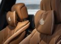 Close-up of two brown leather car seats with headrest pillows featuring the Maybach logo, detailed stitching, and perforated patterns—exclusively designed for the limited edition Mercedes-Maybach S 680.