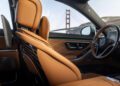Interior of a limited edition Mercedes-Maybach S 680 with tan leather seats and a view of the Golden Gate Bridge through the window.