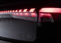 Close-up view of the rear end of a 2026 INFINITI QX80 SPORT Grade 4WD, showcasing illuminated tail lights and bold vehicle badging as the new model ups the luxury game.