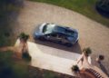 A Lamborghini Bespoke Temerario sports car is parked on a gravel driveway next to a landscaped lawn and stone steps, evoking the luxurious vibe of Porto Cervo.