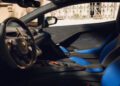 Close-up view of a luxury Lamborghini sports car interior featuring blue and black leather seats, detailed door panel, and modern dashboard with visible steering wheel—an exclusive look at bespoke Temerario design inspired by Porto Cervo.