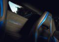 Close-up of a Lamborghini car interior featuring black and blue seats with the Lamborghini logo and "Temerario" embroidered on the rear panel, inspired by the luxury of Porto Cervo.