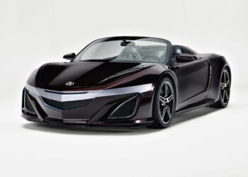 A sleek, dark purple convertible sports car with a low profile and modern design is showcased against a plain white background—perfect for the spotlight at Monterey Car Week or a high-profile 2026 Auction.