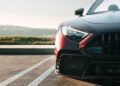 The front of a black sports car, inspired by the BRABUS Rocket GTC Deep Red, breaks cover at Pebble Beach with a striking all-carbon body and an impressive 1000 HP under the hood.
