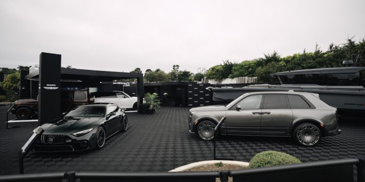 Two luxury cars—a dark green sports car and a silver SUV—are showcased in the outdoor BRABUS exhibition area at Pebble Beach, with a yacht and lush greenery completing the stylish backdrop.