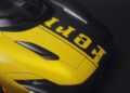 Close-up view of the front hood of a yellow Ferrari Daytona SP3, with the Ferrari logo lettering partially visible in black—a true billionaire’s choice, valued at over $26 million.