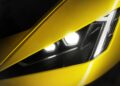 Close-up of a yellow Lamborghini Fenomeno’s headlight, showcasing visible LED lights and a sharp angular design on this limited-run V12 masterpiece unveiled at Monterey.