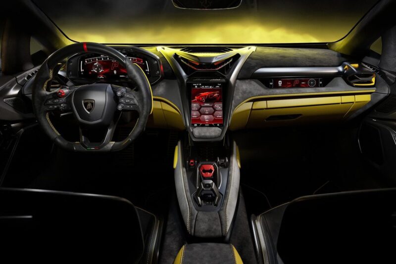 Interior view of the Lamborghini Fenomeno: Limited-Run V12 Masterpiece Unveiled at Monterey, featuring a digital dashboard, touchscreen controls, and yellow-accented leather upholstery.