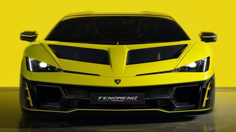 A bright yellow Lamborghini Fenomeno—Limited-Run V12 Masterpiece unveiled at Monterey—is seen from the front, featuring sharp headlights, black grille details, and a license plate labeled "FENOMENO.