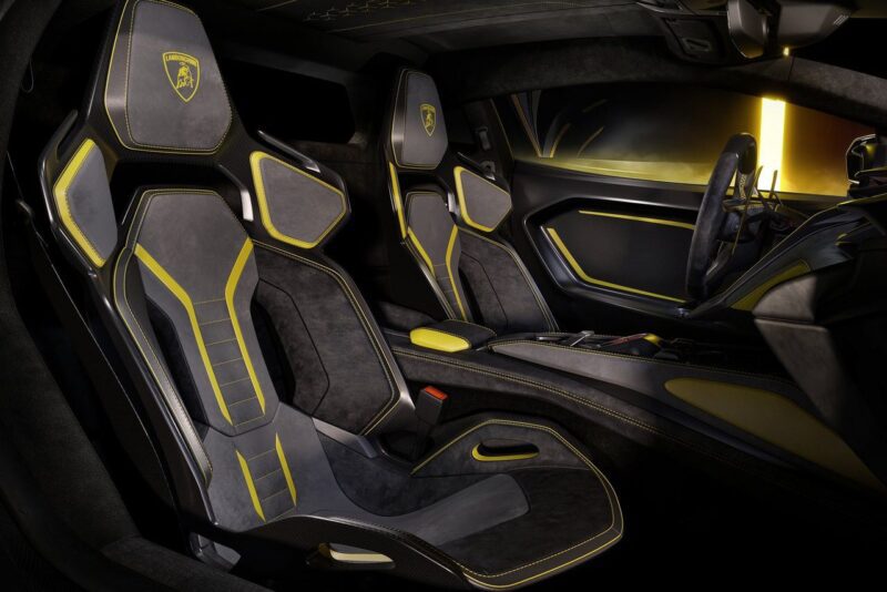 Interior of a modern Lamborghini Fenomeno sports car featuring black and yellow leather seats, a digital dashboard, and sleek, angular design elements: a limited-run V12 masterpiece unveiled at Monterey.
