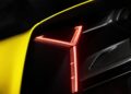 Close-up of a yellow Lamborghini Fenomeno's rear LED taillight illuminated in red, highlighting sharp geometric lines and carbon fiber detailing on this limited-run V12 masterpiece unveiled at Monterey.