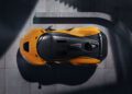 Top view of a McLaren 750S Le Mans parked on a concrete surface, with light and shadow creating geometric patterns around the vehicle—perfectly capturing the spirit of Exotics On Broadway.