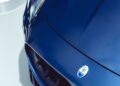 Close-up of the front end of a blue Maserati GT2 Stradale sports car, showing the hood, headlight, logo, and grille—an eye-catching sight at Car Week.