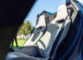 Close-up view of two beige and black sport seats inside a luxury Maserati, featuring the trident logo on the headrests, captured during Car Week.