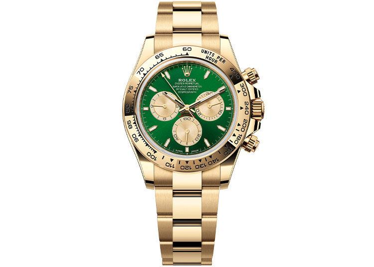 A gold Rolex chronograph watch with a green dial and gold subdials, displayed on a gold metal bracelet—an exceptional choice for watches enthusiasts attending Monterey Car Week.