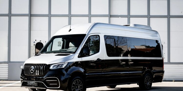 A black and white Mercedes-Benz Sprinter van is parked on a concrete surface in front of a gray industrial building, showcasing the unique creation garage’s latest custom cars for sale.