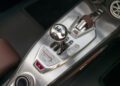 Close-up of a Hennessey Venom F5’s center console featuring a manual gear shift, metallic trim, and brown leather accents.