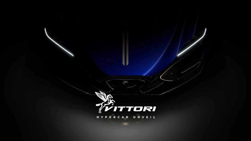 A dark image shows the front of a blue AI-engineered hypercar with illuminated headlights, the text “Vittori Hypercar Unveil,” and a winged horse logo, hinting at a Miami debut inspired by Pininfarina design excellence.